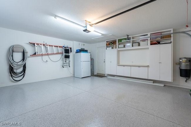 garage with a garage door opener and white refrigerator