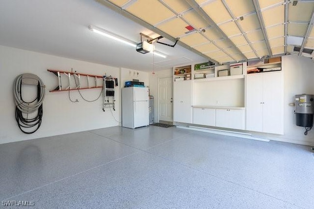 garage featuring white fridge and a garage door opener