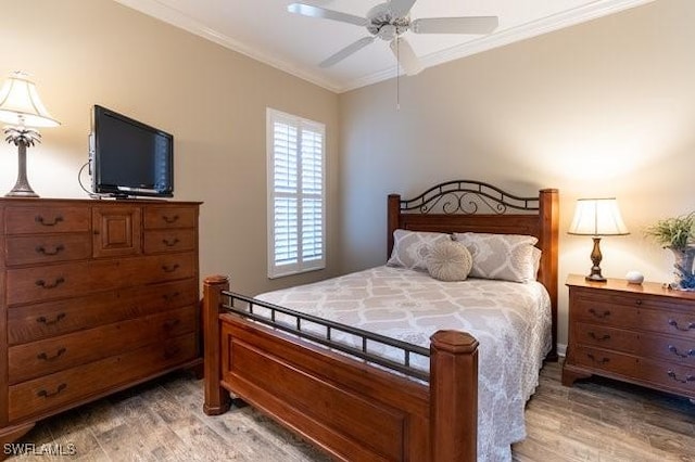 bedroom featuring wood-type flooring, ceiling fan, and crown molding