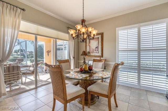 tiled dining area featuring ornamental molding and a chandelier