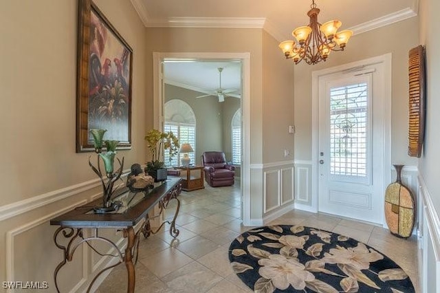 doorway to outside with light tile patterned flooring, ceiling fan with notable chandelier, and ornamental molding