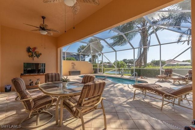 view of patio featuring a lanai and ceiling fan