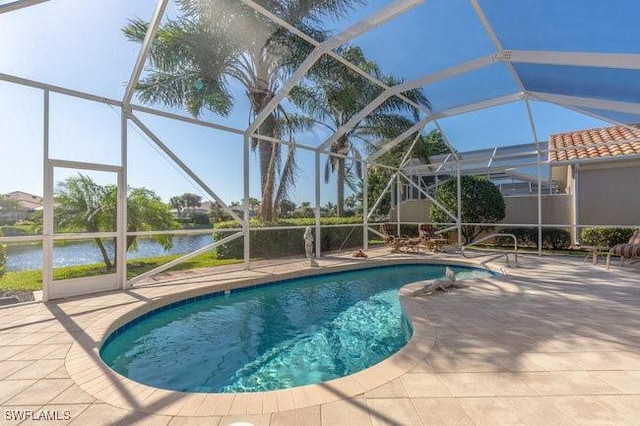 view of swimming pool featuring a lanai, a patio area, and a water view