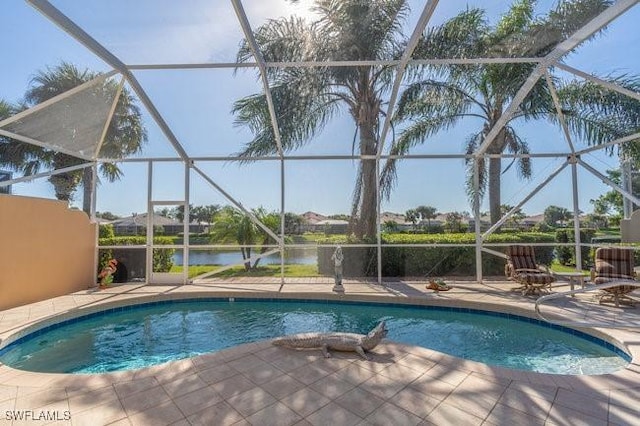 view of pool featuring glass enclosure, a water view, and a patio