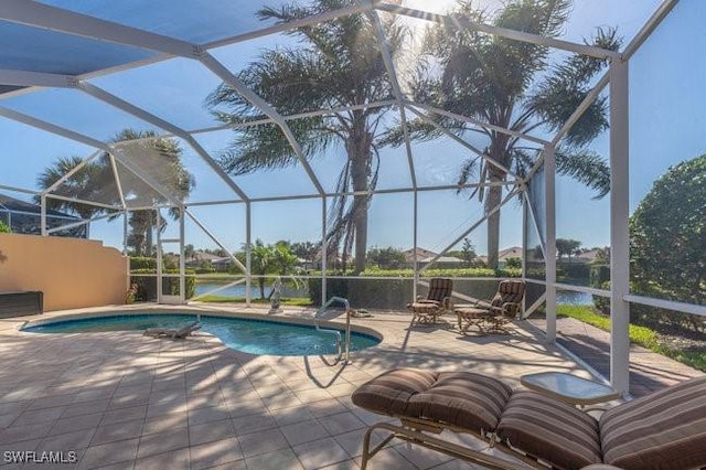 view of swimming pool featuring a water view, glass enclosure, and a patio area