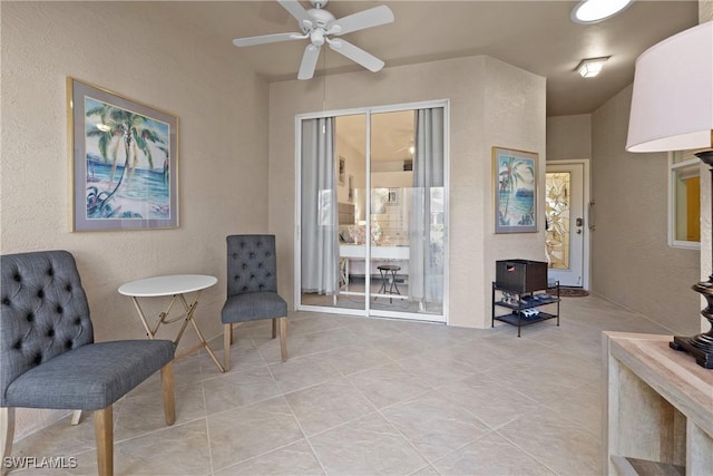 sitting room featuring light tile patterned floors and ceiling fan