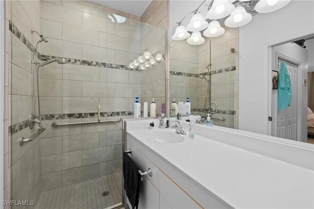 bathroom with vanity and a shower with door