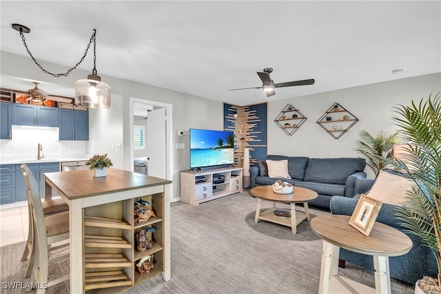 living room featuring sink, light colored carpet, and ceiling fan