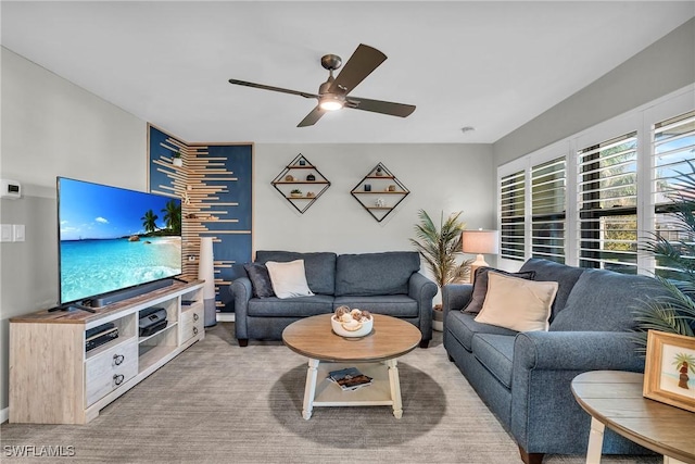 carpeted living room featuring ceiling fan