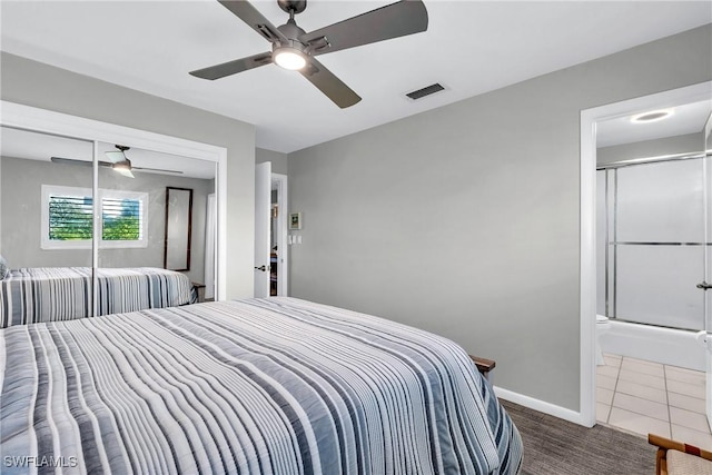 bedroom featuring dark tile patterned flooring and ceiling fan