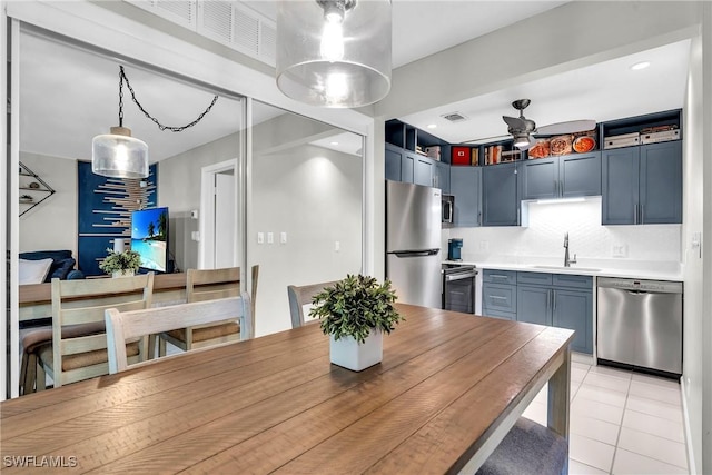 dining room with light tile patterned flooring, sink, and ceiling fan