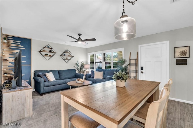 dining room featuring ceiling fan and carpet flooring