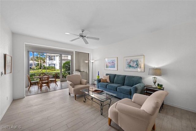 living room with ceiling fan and light wood-type flooring