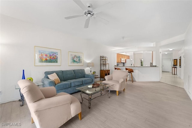 living room with light hardwood / wood-style floors and ceiling fan