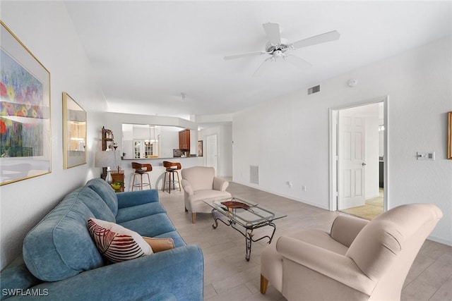 living room with ceiling fan and light hardwood / wood-style flooring