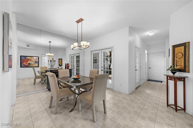 tiled dining area with french doors and an inviting chandelier