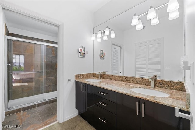 bathroom with a shower with door and vanity