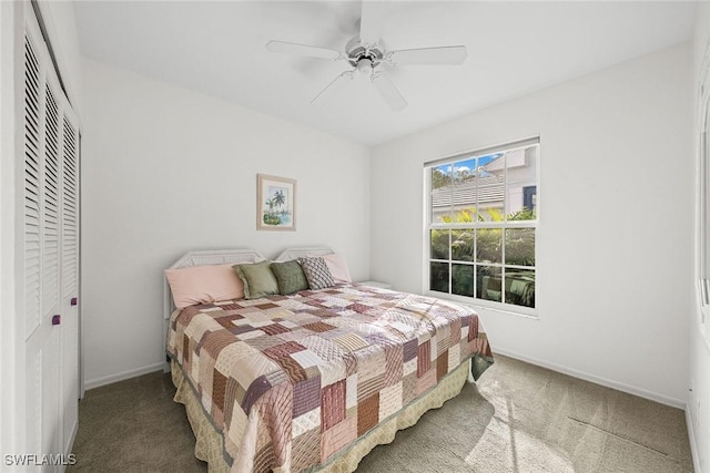 bedroom featuring carpet, ceiling fan, and a closet