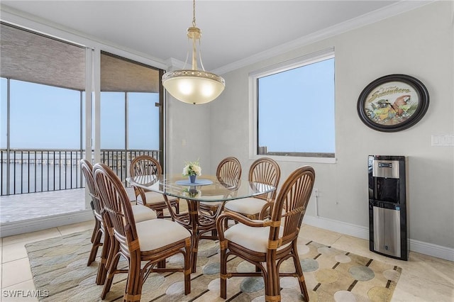 dining area with light tile patterned floors and ornamental molding