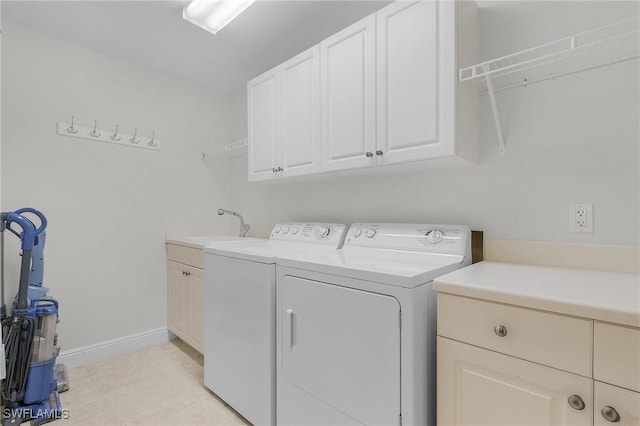 washroom featuring washer and dryer, cabinets, and sink