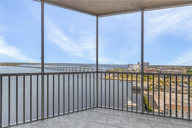 unfurnished sunroom with a water view