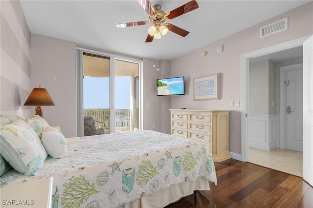 bedroom featuring access to exterior, dark hardwood / wood-style floors, and ceiling fan