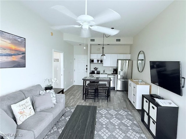 8771 Estero Blvd Unit 103, Fort Myers Beach, FL 33931 - living room with a ceiling fan, dark wood-type flooring, and baseboards
