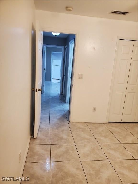 corridor featuring light tile patterned floors