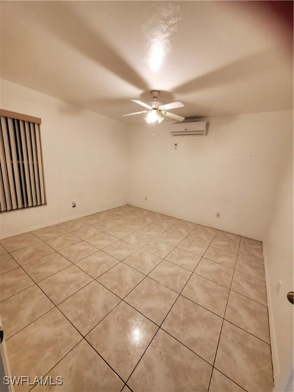 tiled spare room with a wall mounted AC and ceiling fan