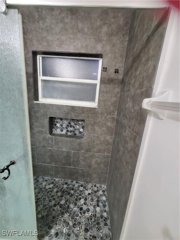 bathroom with tiled shower