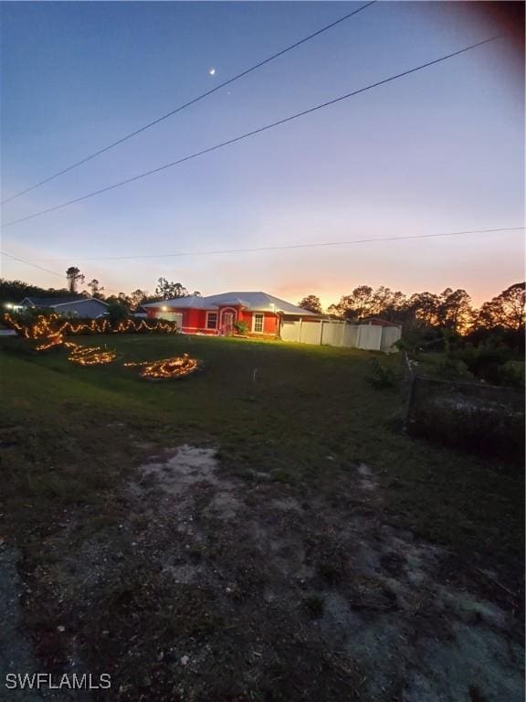 view of yard at dusk