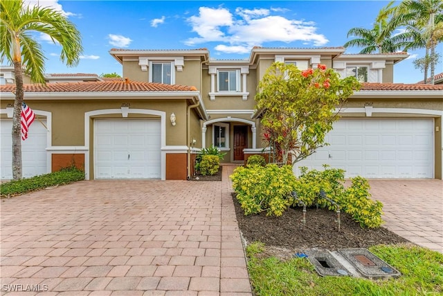 mediterranean / spanish-style house with a garage