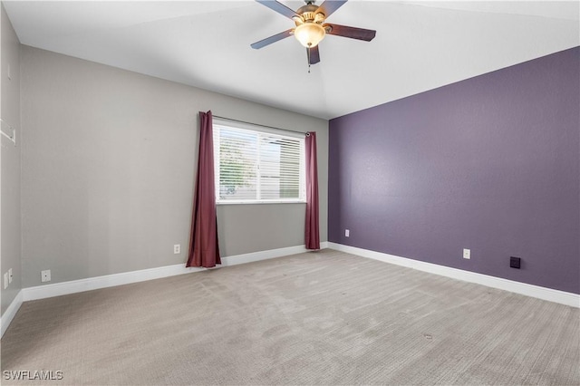 spare room with light colored carpet and ceiling fan