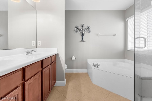 bathroom featuring a bathing tub, tile patterned flooring, vanity, and a healthy amount of sunlight