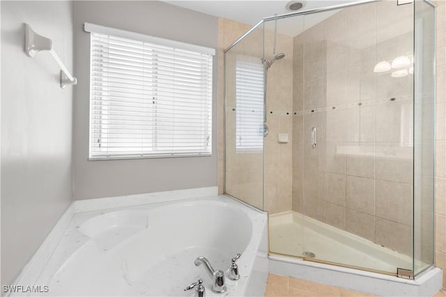 bathroom featuring plus walk in shower and tile patterned floors