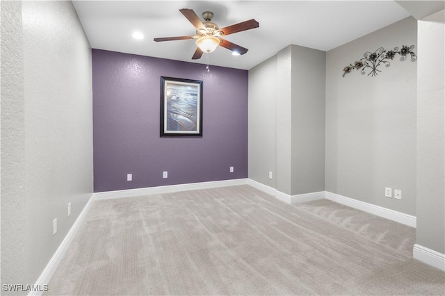 unfurnished room with ceiling fan and light colored carpet