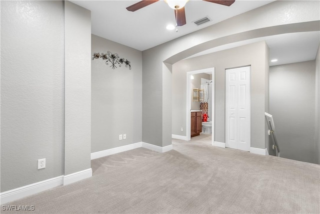 spare room featuring light colored carpet and ceiling fan