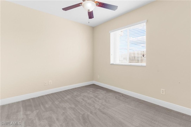 empty room with ceiling fan and light colored carpet