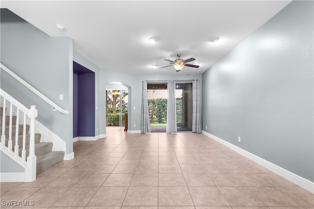 tiled spare room featuring ceiling fan