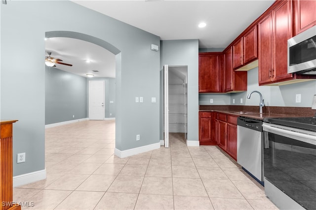 kitchen with ceiling fan, light tile patterned flooring, sink, and appliances with stainless steel finishes