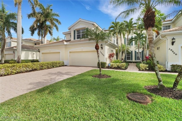 view of front of house featuring a garage and a front lawn