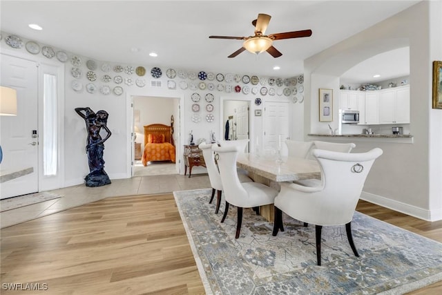 dining area featuring ceiling fan and light hardwood / wood-style floors