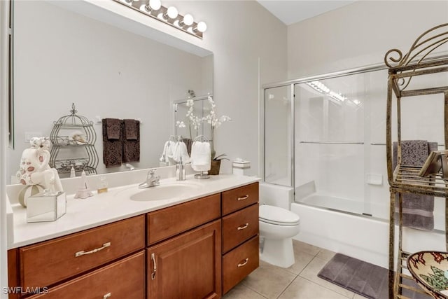 full bathroom featuring tile patterned flooring, toilet, combined bath / shower with glass door, and vanity