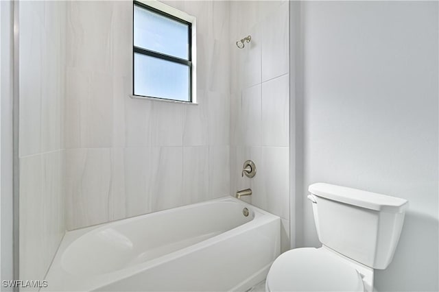 bathroom with bathing tub / shower combination and toilet