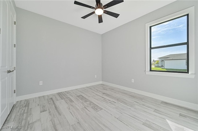 spare room with light hardwood / wood-style flooring and ceiling fan