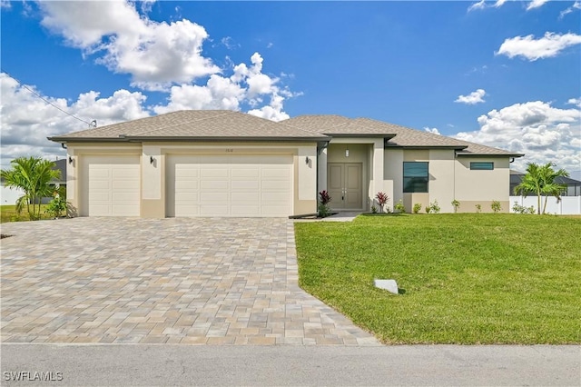 view of front of home featuring a garage and a front lawn