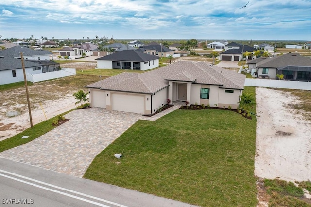 view of front facade featuring a garage and a front lawn