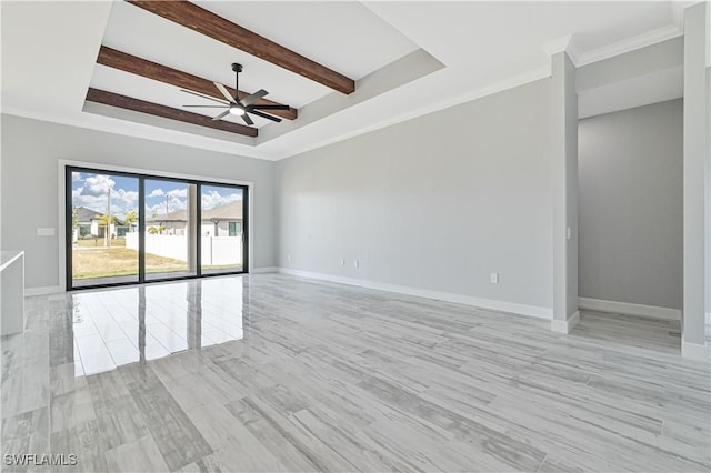 empty room with beamed ceiling, a raised ceiling, light hardwood / wood-style flooring, and ceiling fan