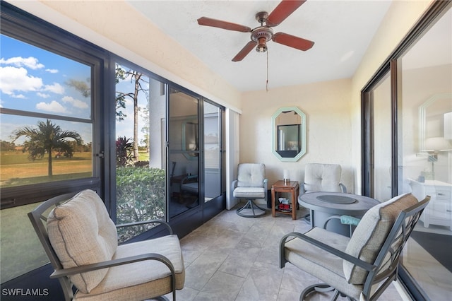 sunroom featuring ceiling fan