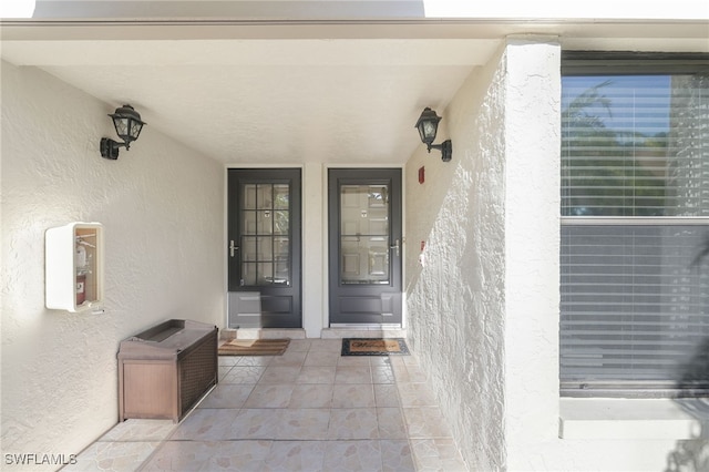 entrance to property with stucco siding